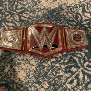Wwe red universal toy championship belt. Never used. Only for display.
